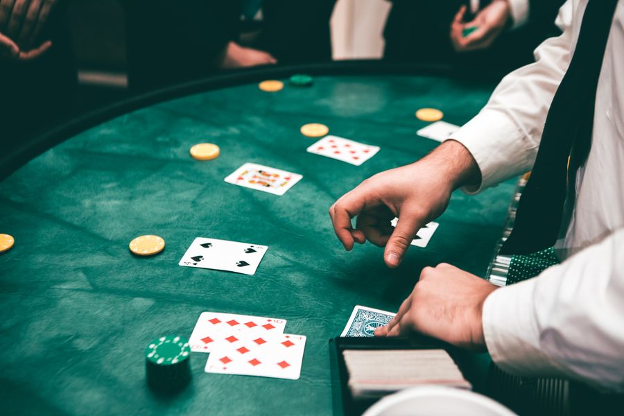 Dealer kasino membagikan kartu di meja hijau